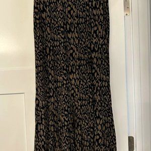 Black background with creamy tan print skirt